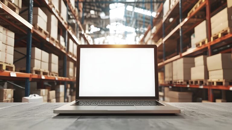 Laptop with Blank Screen in Modern Warehouse Inventory Management Concept